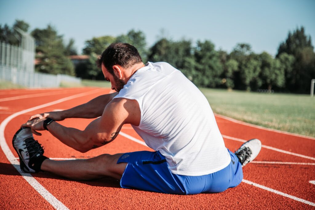 athlete stretching on a running track